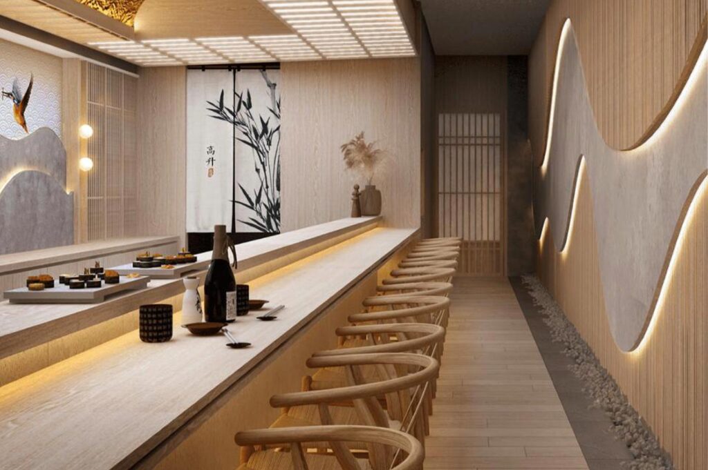 Upscale Japanese restaurant interior featuring a long wooden sushi bar, curved backlit wall panels, light wood ceiling slats, and traditional bamboo-themed sliding doors.