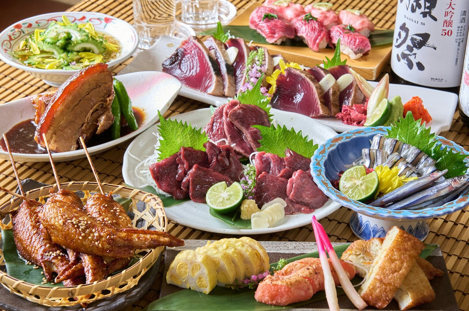 A beautifully arranged table showcasing various plates of seasonal Japanese dishes and drinks for an omakase experience.