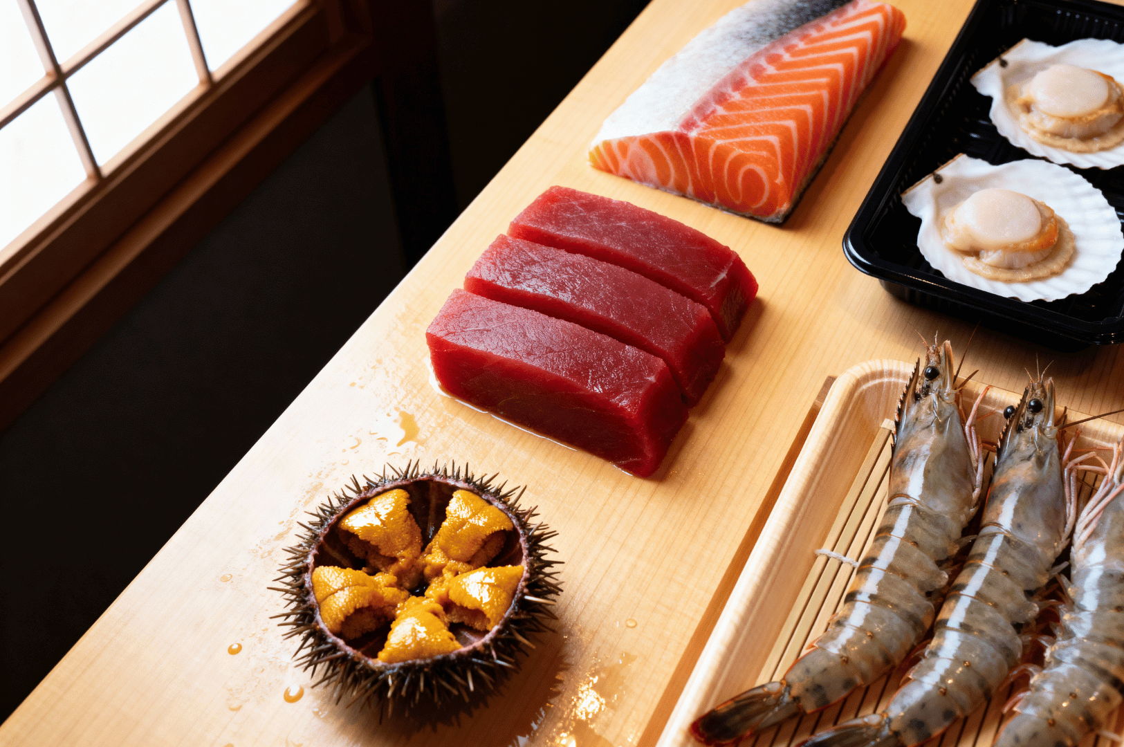 Premium sushi-grade seafood selection featuring raw tuna, salmon, scallops, shrimp, and uni—ideal ingredients for crafting refined omakase experiences.