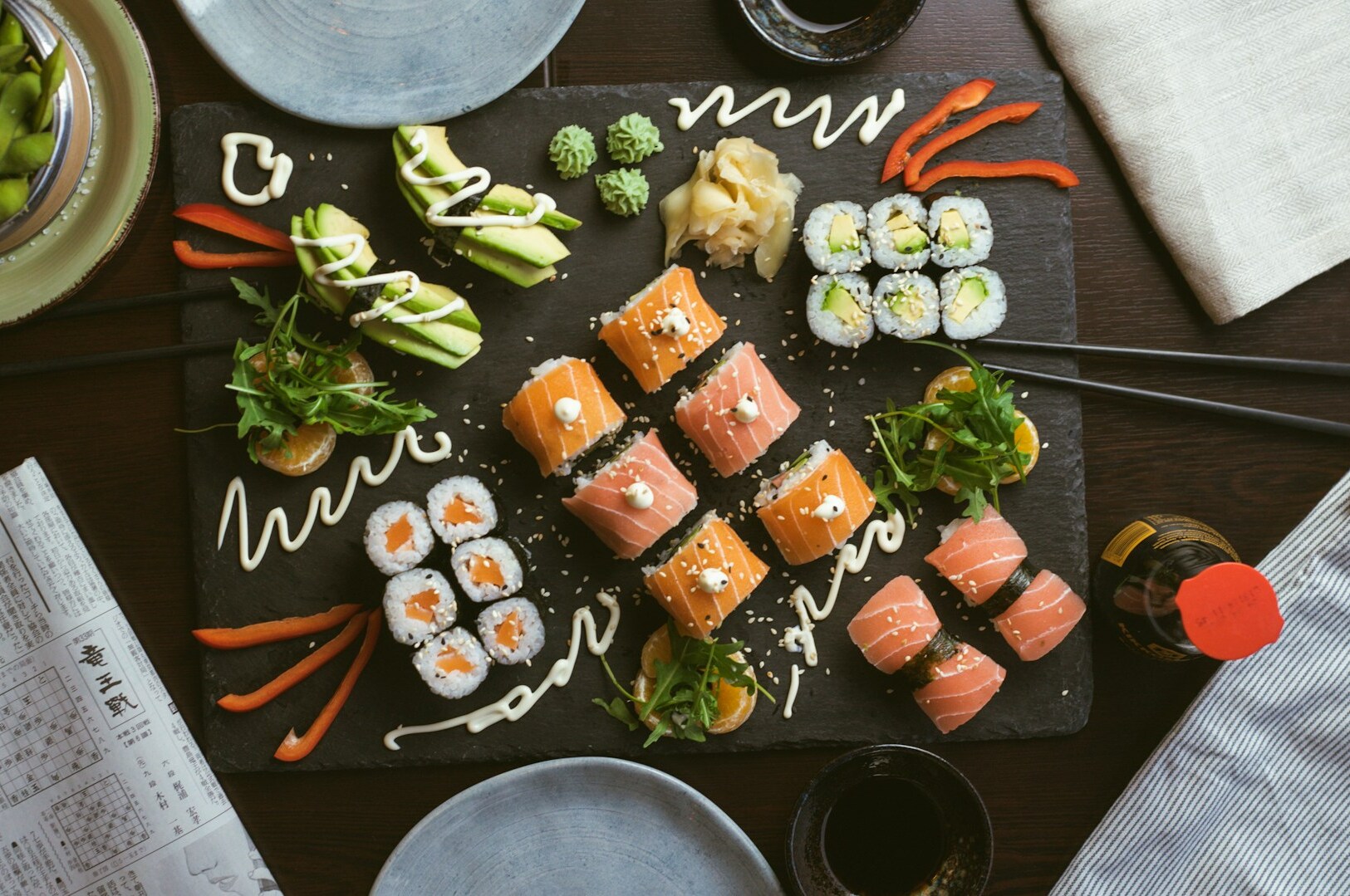 A table set with an array of sushi and seasonal Japanese dishes, showcasing the beauty of Japanese cuisine.