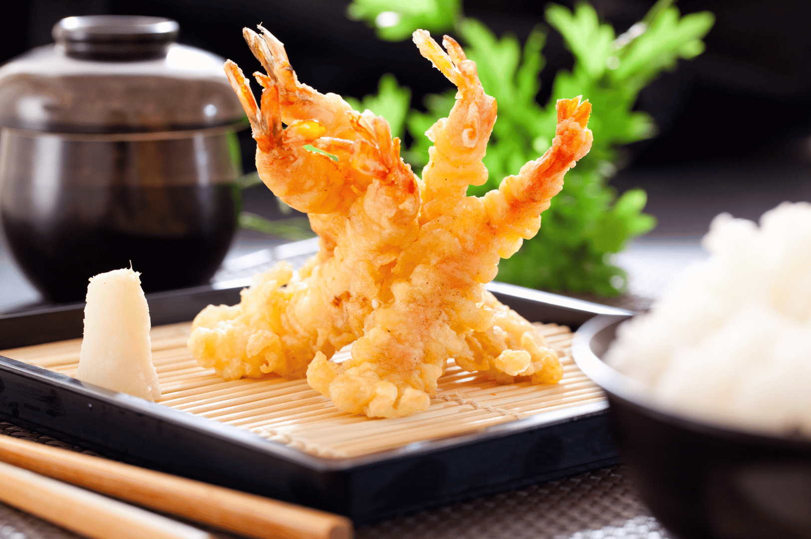 Upright Japanese Tiger Prawn tempura plated on a bamboo mat with pickled daikon and a bowl of white rice, framed by a lidded soup container and green garnish—an artful pause in Yamato’s omakase journey, where visual balance and culinary restraint invite expert scrutiny.
