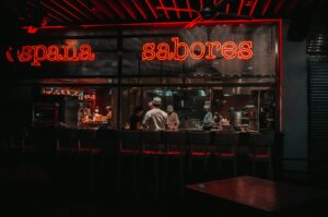 Neon signs illuminate a lively restaurant, showcasing a welcoming atmosphere for sushi lovers.