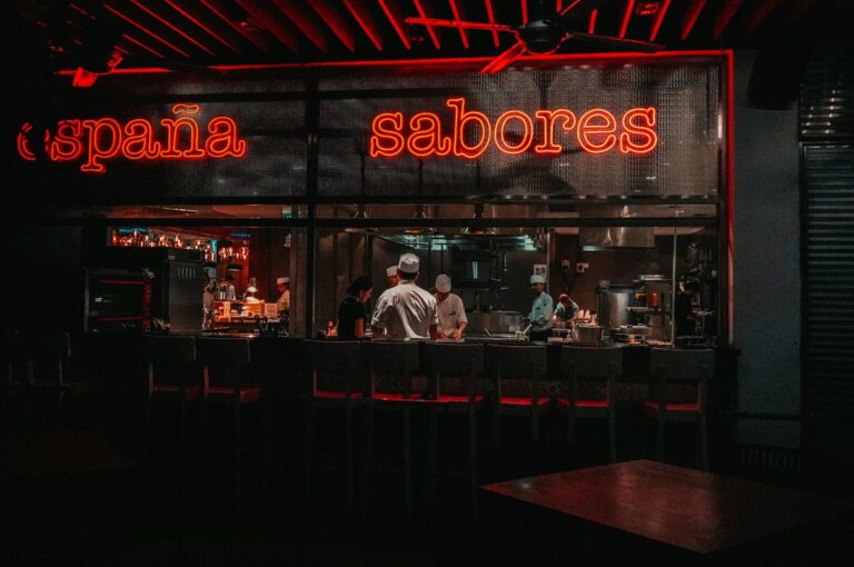 Neon signs illuminate a lively restaurant, showcasing a welcoming atmosphere for sushi lovers.
