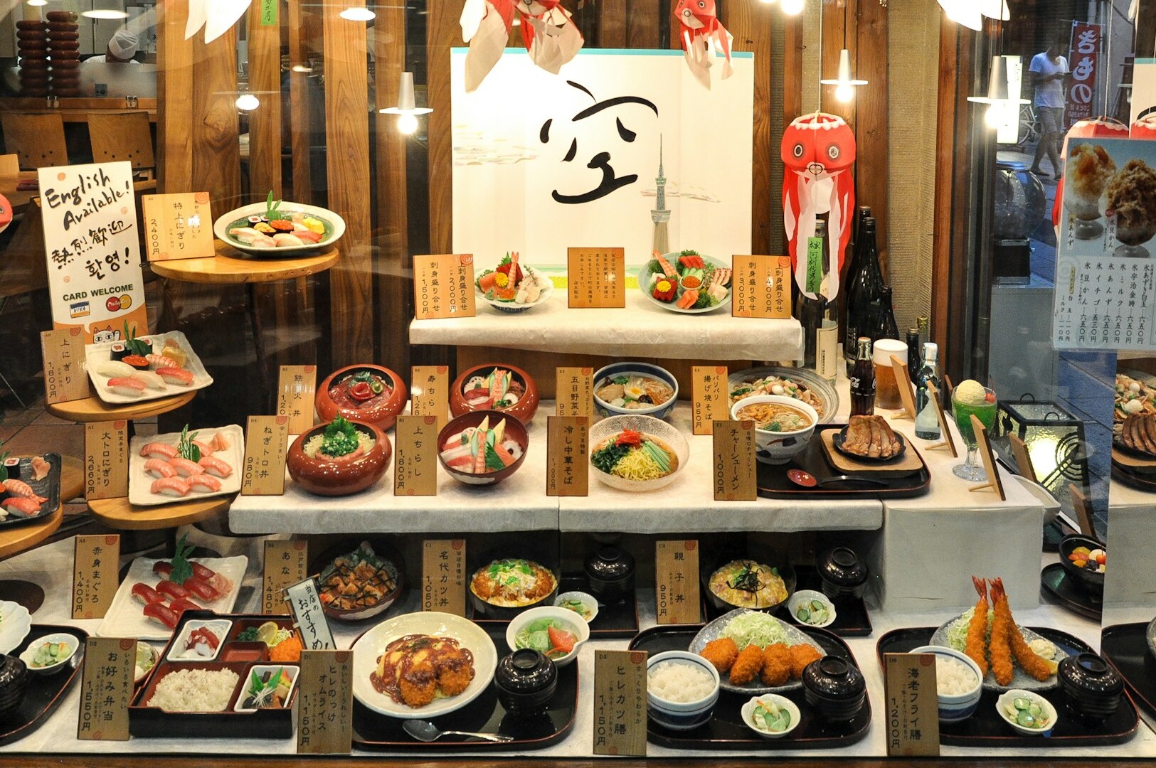 An assortment of Japanese cuisine, featuring sushi and other dishes, highlighting diverse dining styles in a colorful arrangement.