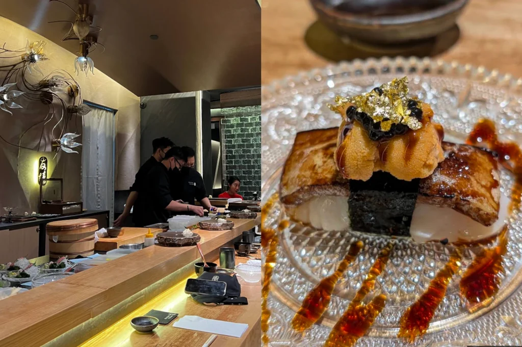 A split-screen image highlighting an elegant sushi bar and a luxurious signature dish. On the left, a long wooden sushi counter is seen under warm, artistic floral lighting fixtures, with chefs in black uniforms preparing food behind the bar. The right side focuses on a decadent piece of sushi served on a crystal plate, consisting of a large scallop topped with seared wagyu beef, creamy sea urchin (uni), black caviar, and a shimmering leaf of edible gold, all drizzled with a rich balsamic-style glaze.