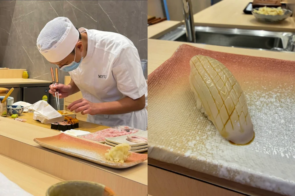 This split-screen image captures the meticulous preparation and presentation of high-quality sushi. On the left, a chef wearing a white "MIYU" uniform, a white cap, and a blue face mask is seen at a wooden sushi counter, carefully using silver chopsticks to arrange uni (sea urchin) onto a row of gunkan maki. The right side features a close-up of a single piece of Ika (squid) nigiri served on a textured, gradient-colored ceramic plate; the squid is expertly scored in a diamond pattern and glazed with a light soy reduction, showcasing the precision of the knife work.