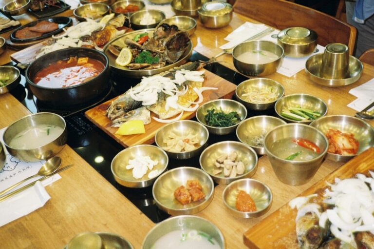 A buffet table featuring multiple bowls of Japanese cuisine and silverware, representing smart dining options in Singapore.