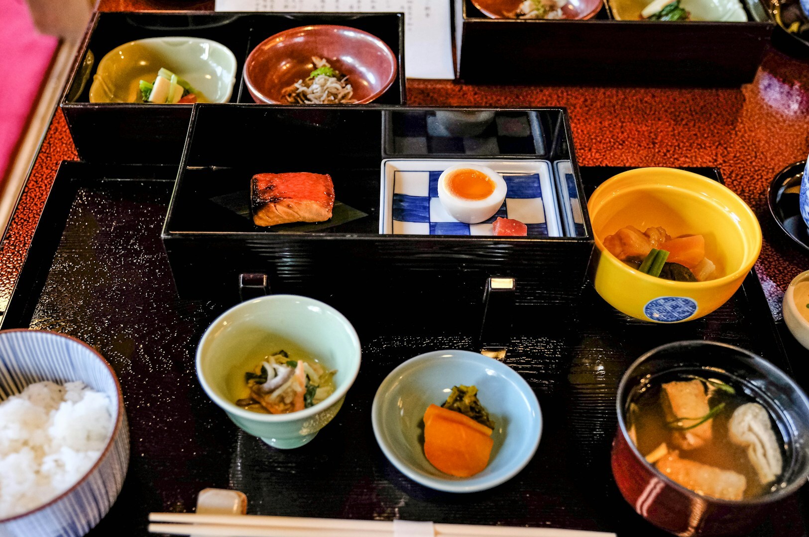 A beautifully arranged Japanese meal on a tray, featuring an assortment of traditional dishes.