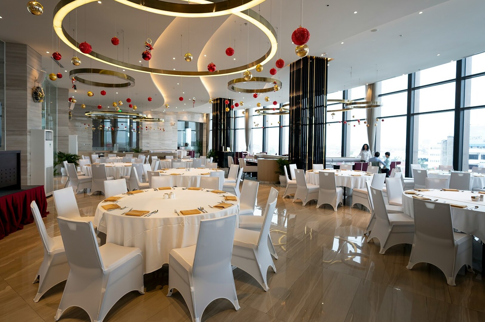 The image depicts an elegant restaurant dining room featuring sophisticated table settings and soft ambient lighting, creating a warm atmosphere for diners. This inviting space is perfect for enjoying high quality Japanese fare and fusion cuisine, appealing to a new generation of food lovers.