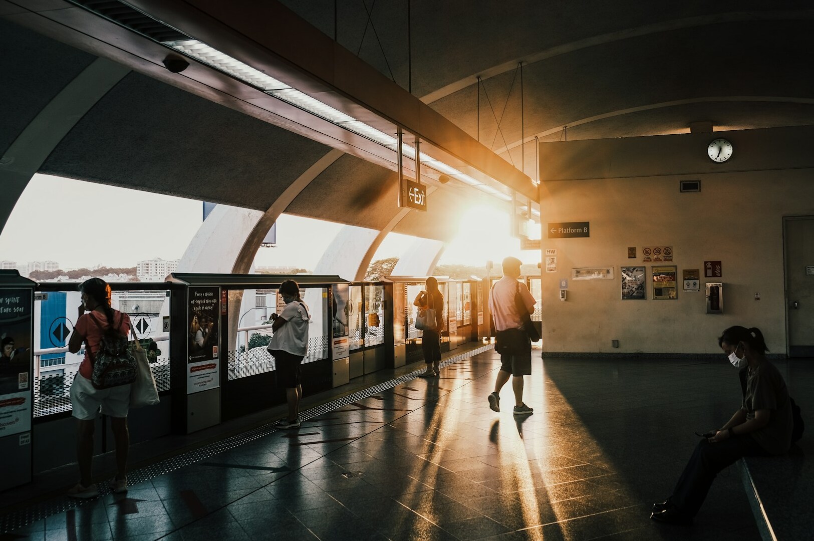 Commuters waiting for the train at Upper Thomson MRT, surrounded by station signage and the platform area.