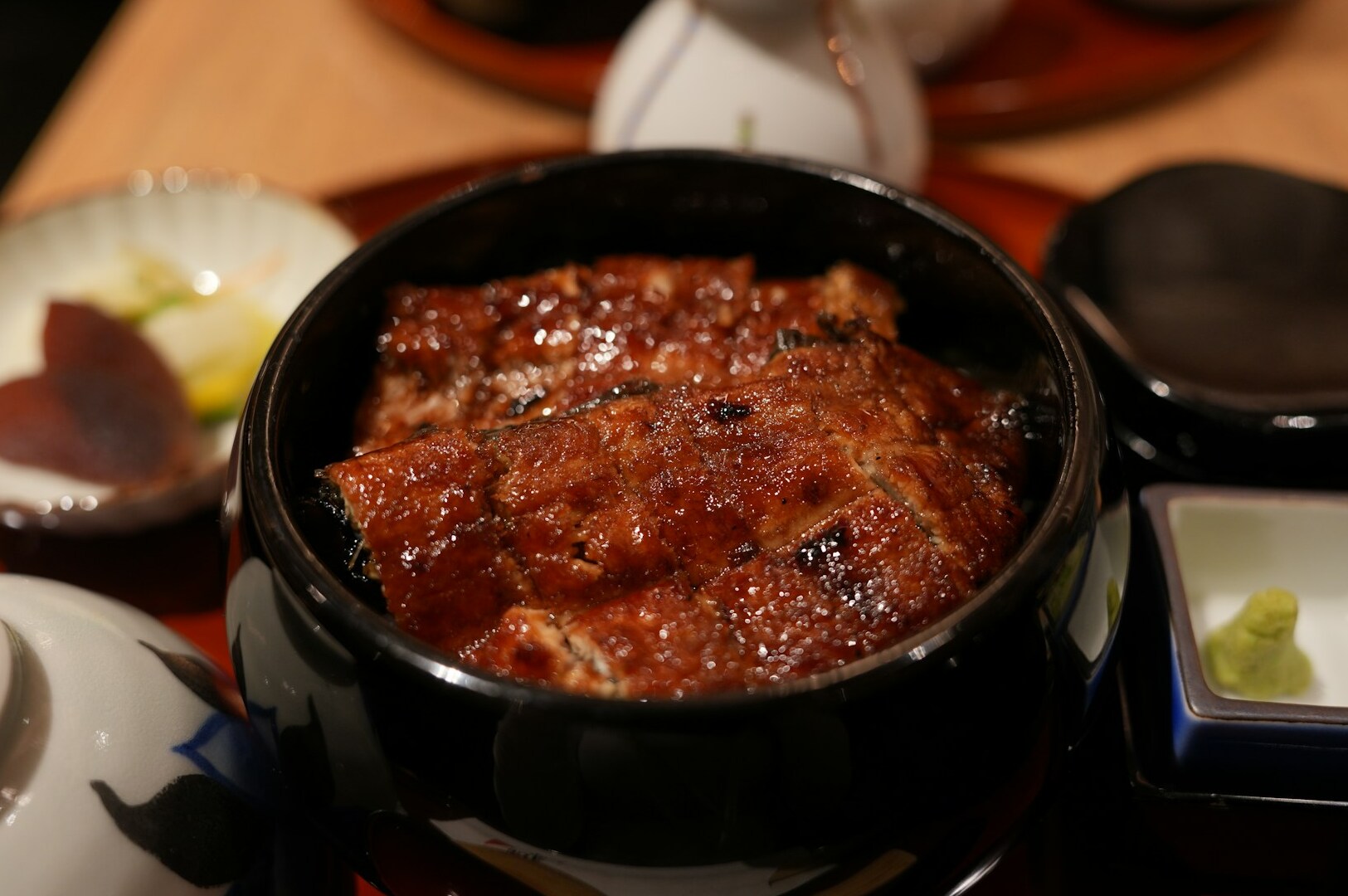 A black pot of Unagi filled with meat sits on a table at Omote Thomson Plaza.