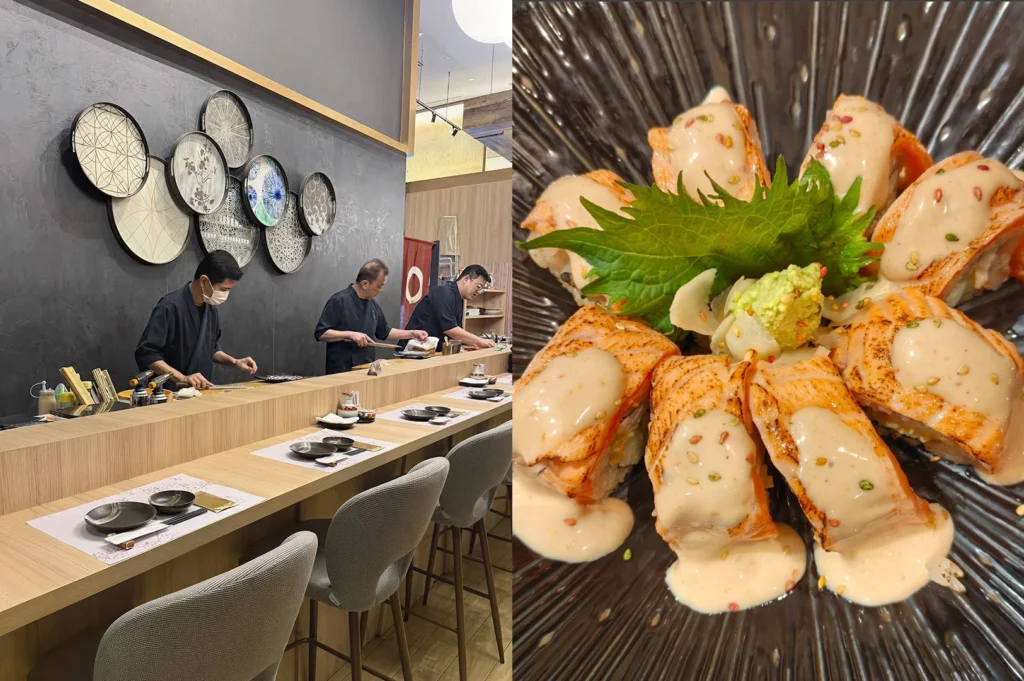 A split-screen image. The left side shows a sleek restaurant interior with three chefs in black uniforms working behind a long light-wood counter; the dark grey back wall is decorated with several circular, backlit panels featuring traditional Japanese patterns. The right side is a top-down view of a plate of aburi (flame-seared) salmon rolls arranged in a circle, topped with a creamy white sauce, sesame seeds, and a central shiso leaf garnish.
