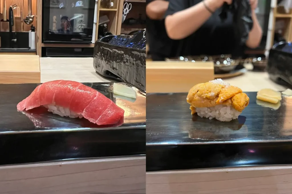This split-image display highlights two separate pieces of nigiri served on a minimalist, dark, rectangular serving platter in an omakase setting. The left side showcases a brilliant, deep-red piece of tuna nigiri, while the right side features a vibrant, textured piece of uni (sea urchin) nigiri, both placed against a clean, light-toned background that emphasizes their fresh, high-quality appearance.