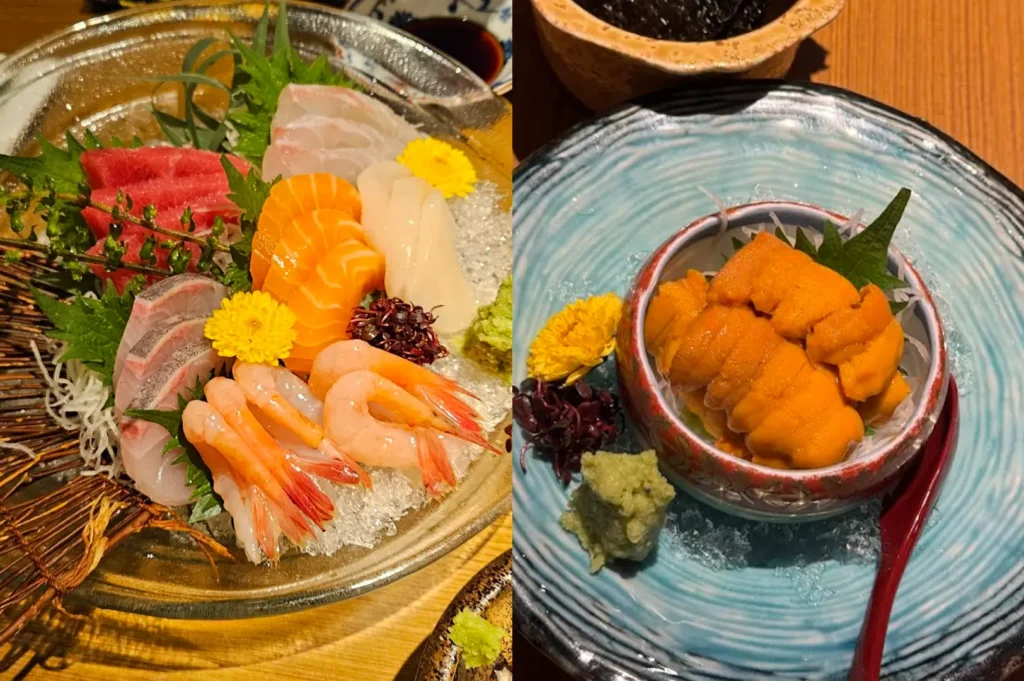 A visually striking split-image showcasing two refined Japanese dishes served in a quiet, upscale setting. On the left, a glass plate is filled with a colorful arrangement of assorted sashimi, including tuna, salmon, and shrimp, garnished with fresh leaves and delicate yellow edible flowers on a bed of crushed ice. The right side features a small, ceramic bowl filled with bright orange uni, accompanied by a small pile of fresh wasabi, all served on a textured blue plate with a matching spoon.